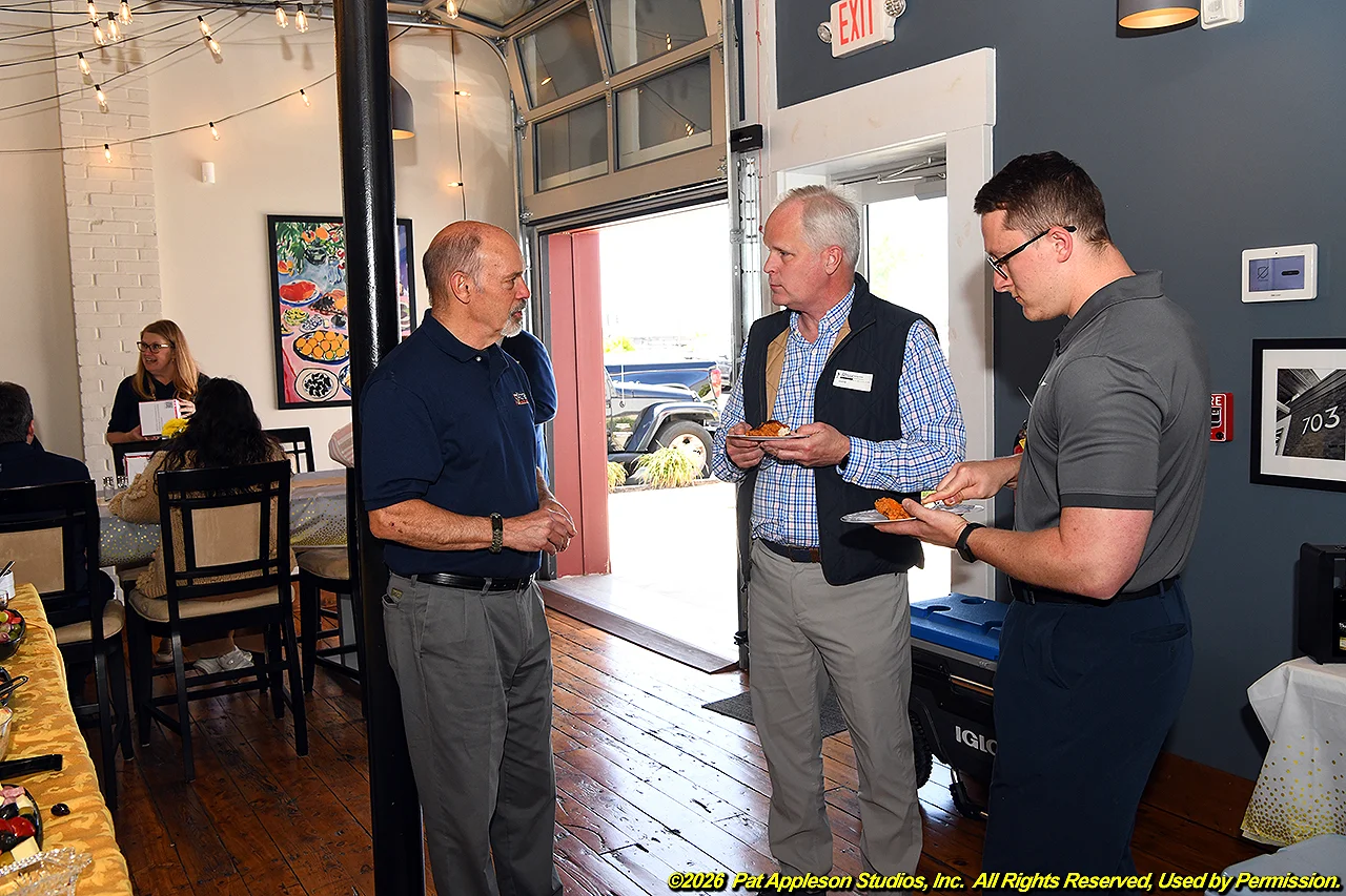 Ed talking to insurance guys in kitchen