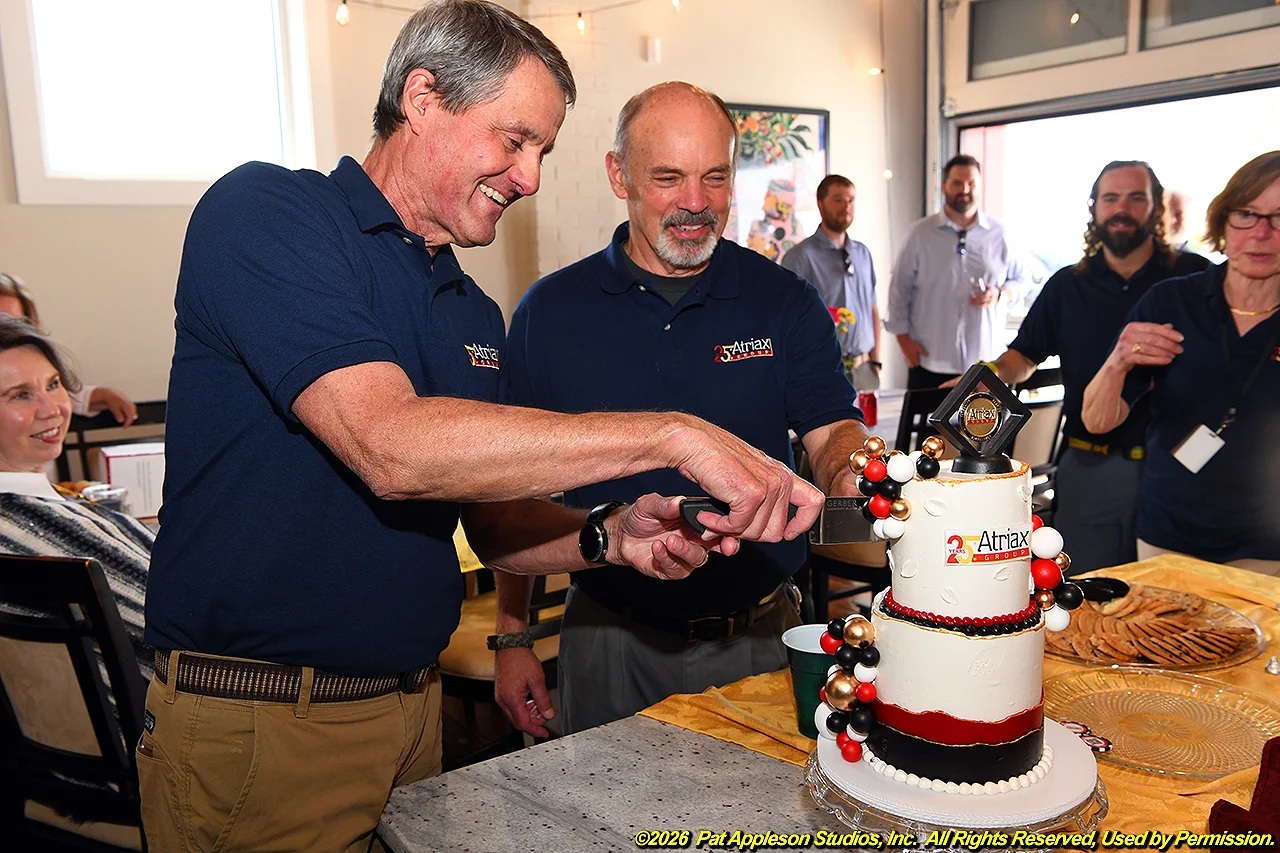 George and Ed cutting cake