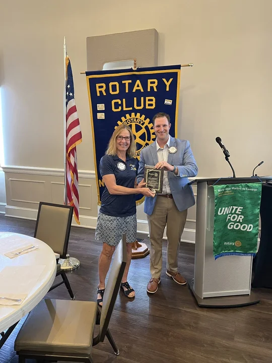 Kim receiving Rotary plaque